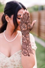 A bride showing off her henna menhndi on the backyard