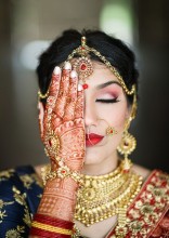 Bride posing for henna pic with beautiful color of henna by Nisha Henna Arts
