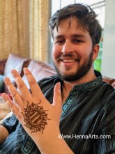 A groom posing with henna before wedding