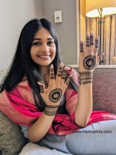 Young girl posing with henna on a sangeet event