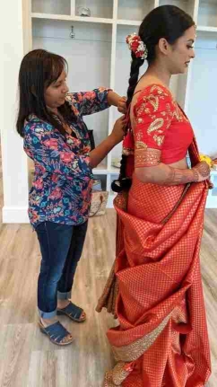 Nisha helping bride with saree